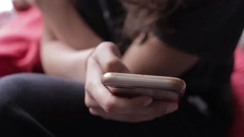 Close up of young person texting or scrolling on iPhone Stock Footage 146498097
