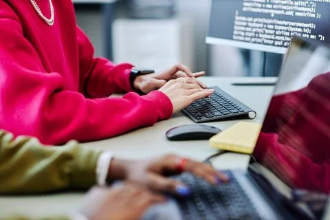 Close up of young person typing at computer keyboard writing code 写真素材
