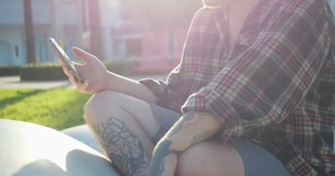 Close-Up Of Young Person Using Smartphone While Relaxing Outdoors... 库存影片 333525055
