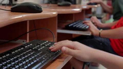 Close-up of a young persons hand pressing keys on a computer keyboard in a Stock Footage 318714363