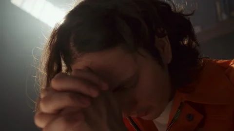 Close-Up of Young Prisoner Saying Prayer with Hands Clasped Stock Footage 310336751