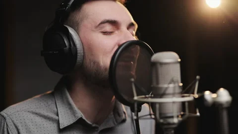 Close up of an young professional smiling energetic caucasian male singer Stock Footage 194764077