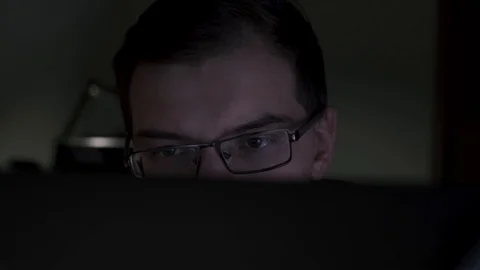 Close-up of young programmer looking closely at monitor. Stock footage. Young Stock-Footage 114887055