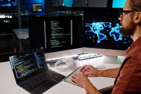 Close-up of young programmer or software developer decoding data Stock Photos