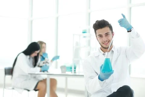 Close up. the young scientist makes the analysis of the liquid i Stock Photos
