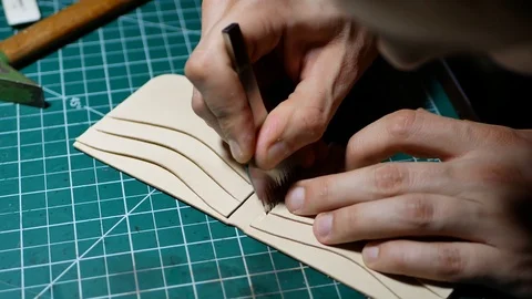 Close up of young shoemaker hand, cutting leather at workshop. Man, wearing in s Stock Footage 101154242