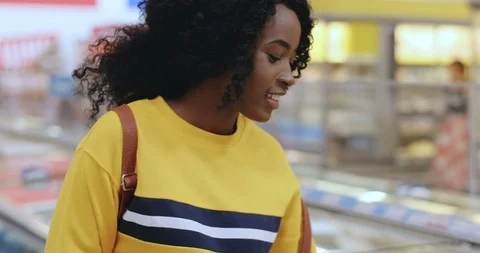 Close up of the young smiled and pretty African American girl buying ice-cream Stock Footage 117629878