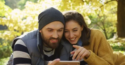 Close up of young smiling couple video chatting on the smart phone and hugging Stock Footage 82513655