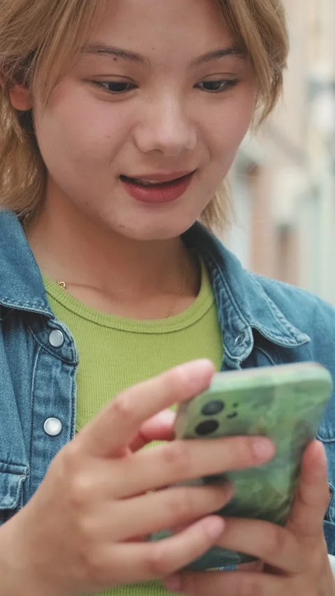 Close-up of young smiling woman using mobile phone Video stock 254915205