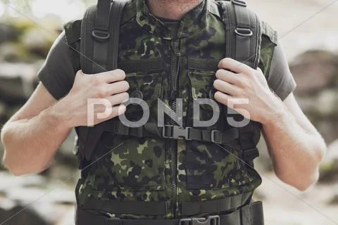 Close up of young soldier with backpack in forest Stock Photos