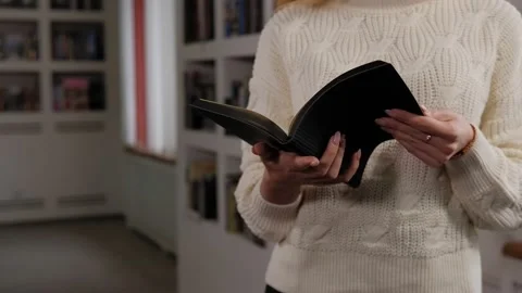 Close-up of a young student holding a softbound book in the library. Stock Footage 145204766