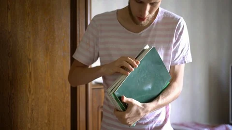 Close up young student holidng bunch of books in university Stock Footage 96170589