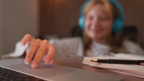 Close-up on a young student's hand using a laptop touchpad for scrolling an.. Stock Footage 345474461