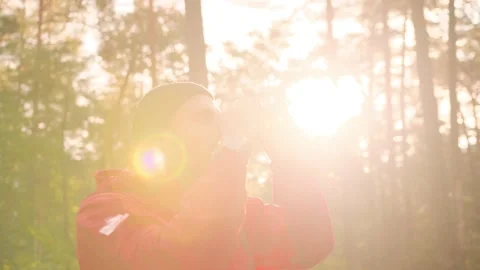 Close up of young stylish caucasian guy standing on among forest glade flooded Stock Footage 147065764