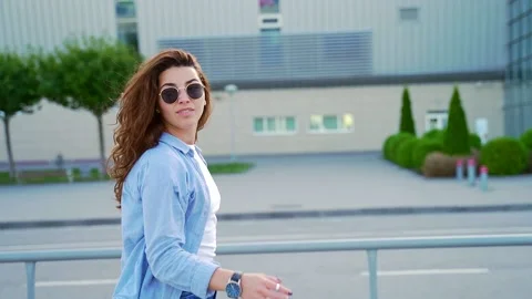 Close Up of Young Stylish Curly Hispanic Woman in Sunglasses Walking Alone  Stock Footage 140116551