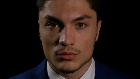 Close up of young successful man looking down and then straight into the came Stock Footage 74678810