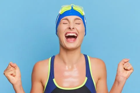 Close-up of young swimmer happy with result of her swim, posing in swimsuit and Foto stock