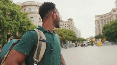 Close-up of young tourist man standing in the square of the old city, looking at Stock Footage 227093659