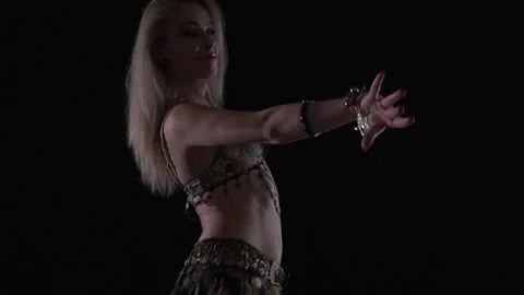 Close up of a young woman dancing an eastern dance in a dark room Stock Footage 138006013