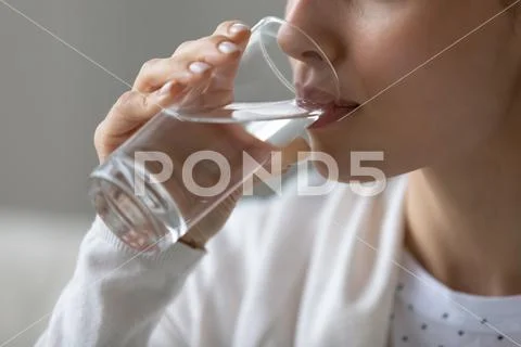 Close up of young woman drink clean water Stock Photos