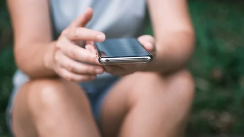 Close up of young woman hands using and holding smart phone, scrolling up and Stock Footage 199214119