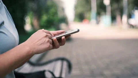 Close up of young woman hands using and holding smart phone, scrolling up and Stock Footage 199214367