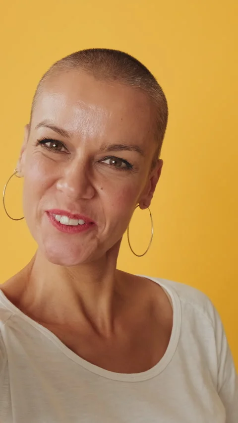 Close-up, young woman looking at camera making video call, isolated on yellow Stock Footage 255964872