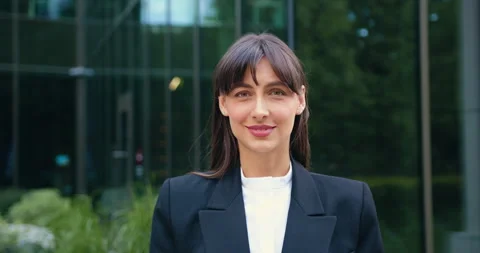 Close-up of a young woman posing for the camera and smiling, standing outdoors Stock Footage 316761400