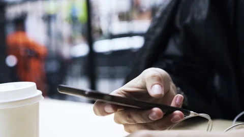 Close up of young woman s hand with a modern smartphone outside Stock Footage