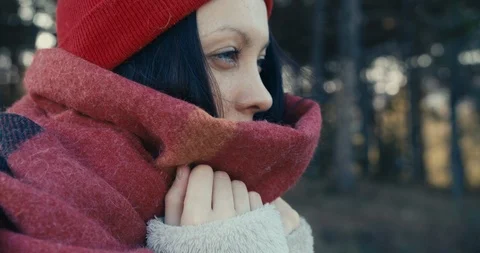 Close up of a young woman in a scarf in a pine forest. Cold weather. Stock Footage 118524853