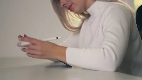 Close up of young woman sitting at her desk she's drawing, writing and using  Stock Footage 143009853