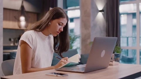 Close up young woman sitting using laptop headphones notebook typing message Stock Footage 143593750