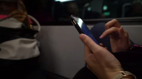Close up of young woman using iPhone smartphone on train ride Stock Footage 122175697