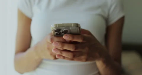 Close-up young woman using smartphone in living room at home. Stock Footage 336654087