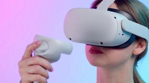 Close up of young woman using vr goggles and controller isolated over neon Stock Footage 213516957