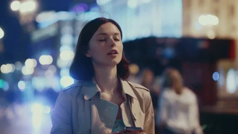 Close up young woman walking using mobile phone to type a text message in the Stock Footage 156459038