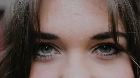 Close-Up of Young Woman’s Blinking Eyes, windy hair Stock Footage 131091096