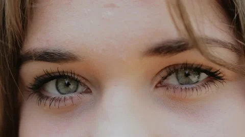 Close-Up of Young Woman’s blinking Grey Eyes, windy hair Stock Footage 131081825
