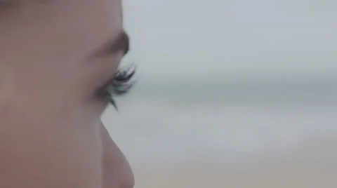 Close up of young woman's eye looking on lonely beach. 動画素材 53747417