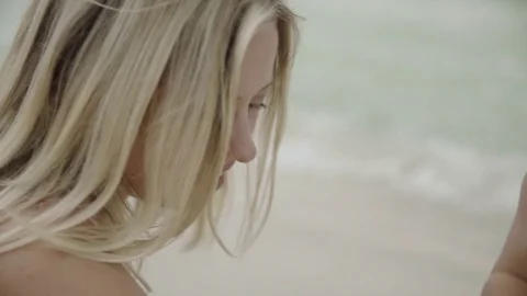 Close up of young woman's eye looking on lonely beach. Portrait of relaxed young Stock Footage 81489281