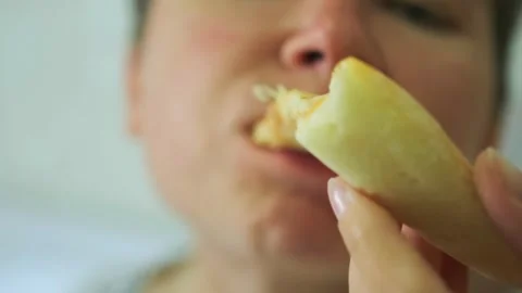 Close up of young woman's face biting into fresh slice of pizza Stock Footage 285207115