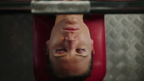 Close-up of a young woman's face during a bench press in the gym Stock Footage 197016945