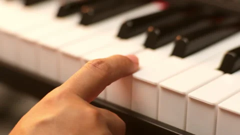 Close-up of young woman's hand playing the piano.  Stock Footage 255696313