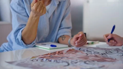 Close-up of a young woman's hand throwing a dice onto the board while playing Stock Footage 307756616