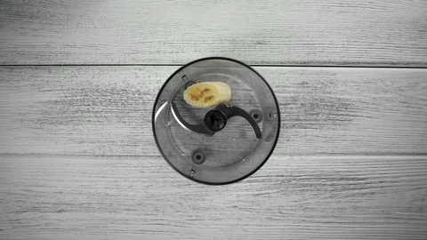 Close Up, Young Woman's Hand Throws Banana Pieces into Blender Stock Footage 102745245