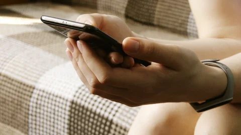 Close up of a young woman's hand typing text message on her smartphone. Cauca Stock Footage 107665016