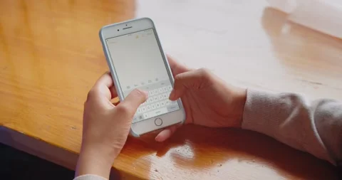 Close up of a young woman's hand typing text message on her smartphone. African Stock Footage 132169855