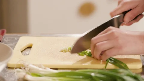 Close-up of a young woman's hands chopping fresh onions Stock Footage 120711184