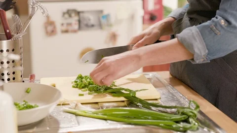 Close-up of a young woman's hands chopping fresh onions Stock Footage 120711318