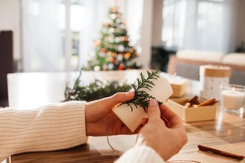 Close-up of a young woman's hands decorating candles for Christmas or New Year Stock Photos